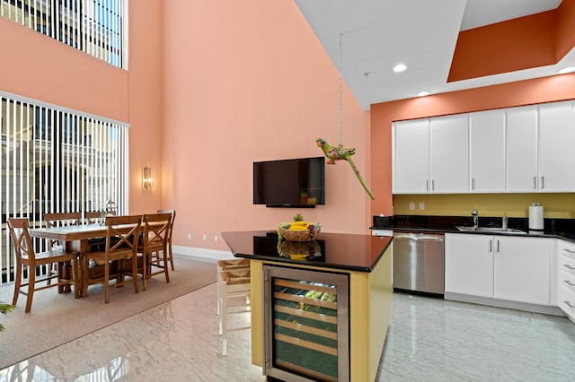 kitchen with wine cooler, marble finish floor, dishwasher, and dark countertops