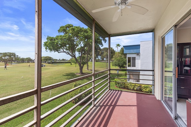 unfurnished sunroom featuring a ceiling fan