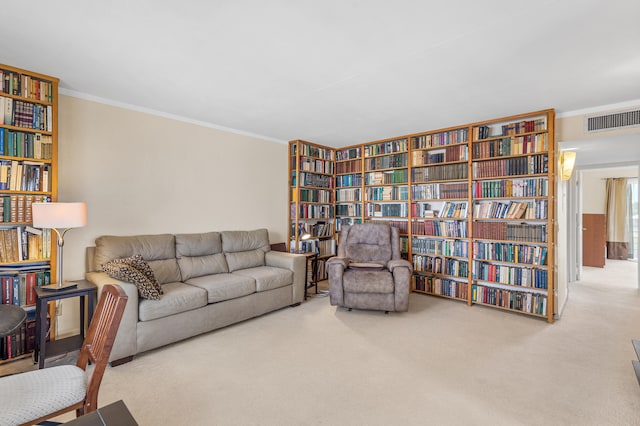 living area featuring visible vents, ornamental molding, and wall of books