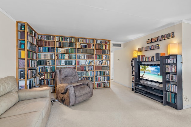 living room with visible vents, carpet floors, crown molding, and bookshelves