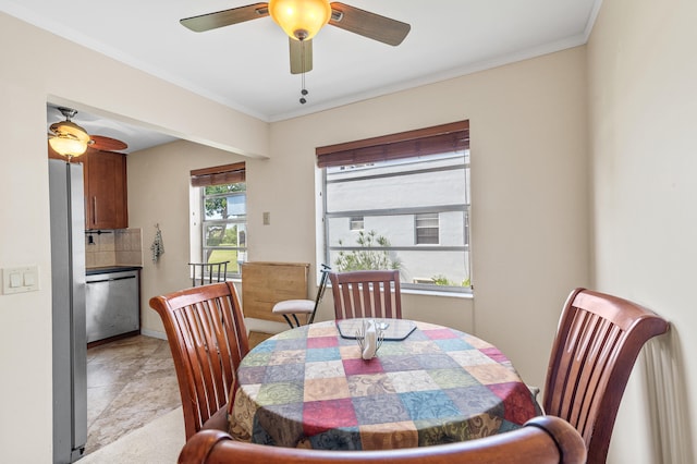 dining area with ceiling fan and ornamental molding