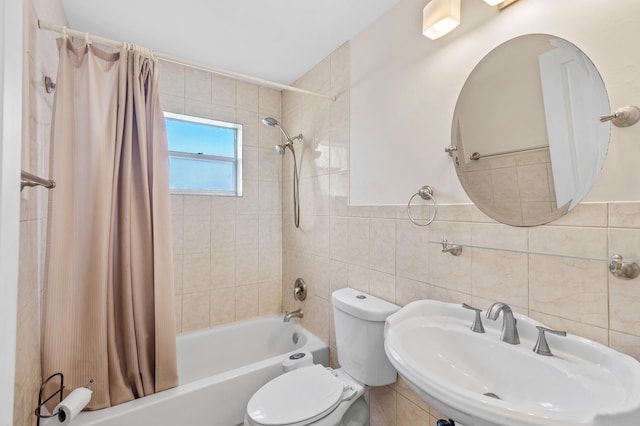 bathroom featuring shower / bath combination with curtain, toilet, tile walls, and a sink