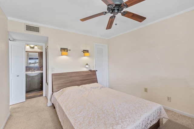 bedroom featuring visible vents, light colored carpet, ornamental molding, and a sink