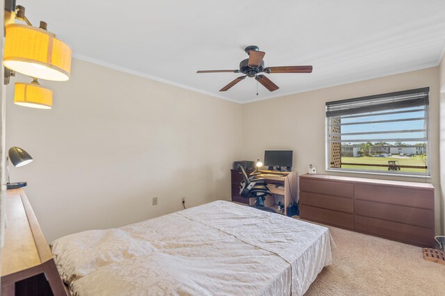 bedroom featuring light carpet, a ceiling fan, and ornamental molding