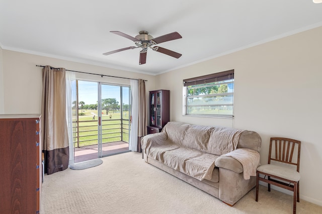 carpeted living area with baseboards, ornamental molding, and a ceiling fan