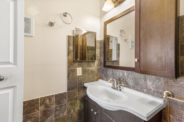 bathroom with tile walls and vanity