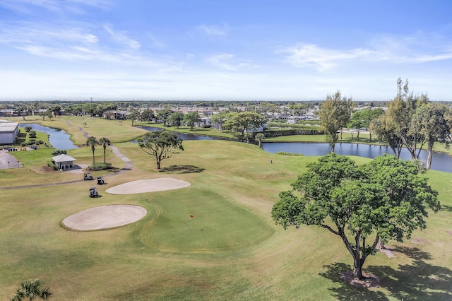 birds eye view of property featuring view of golf course and a water view