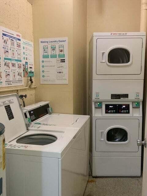 shared laundry area featuring washing machine and clothes dryer and stacked washer / drying machine