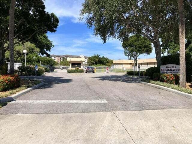 view of street featuring curbs and a gate