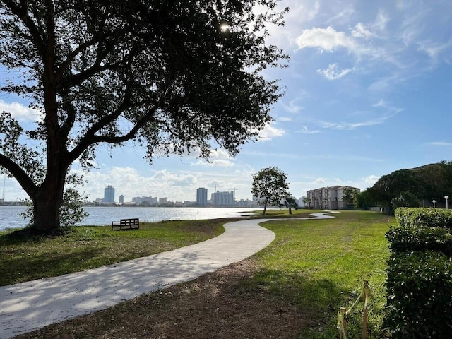 surrounding community featuring a yard, a water view, and a city view