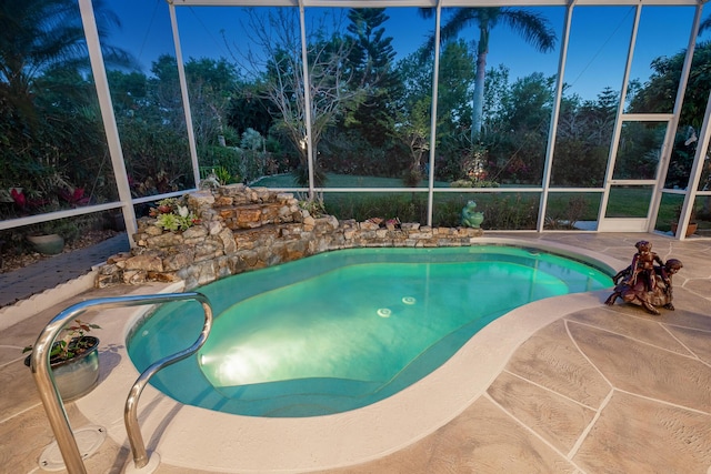 outdoor pool with a lanai and a patio