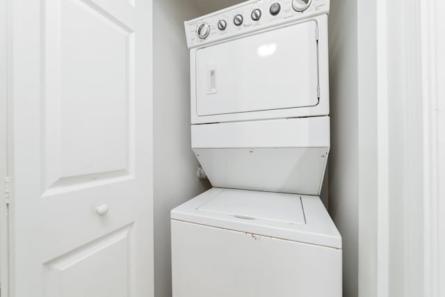 washroom featuring laundry area and stacked washer / dryer