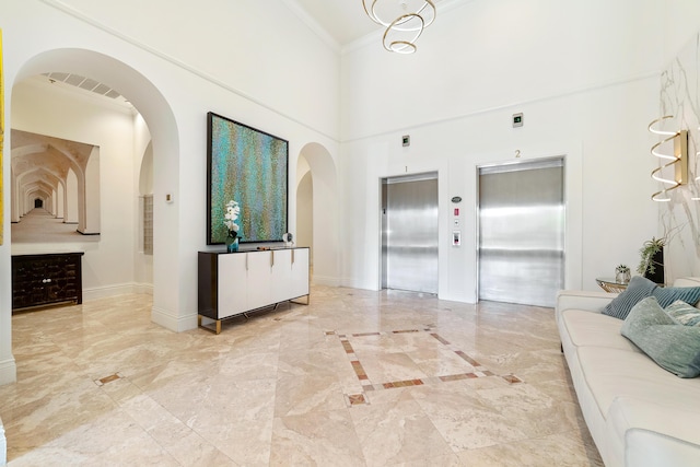 living room featuring elevator, baseboards, arched walkways, and crown molding