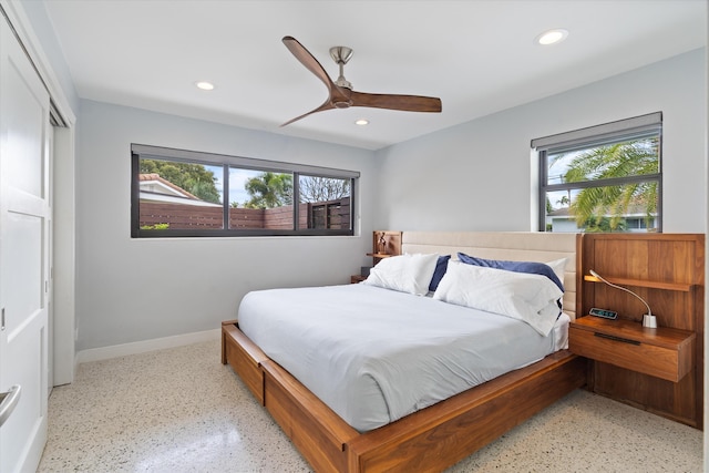 bedroom with multiple windows, baseboards, speckled floor, and recessed lighting