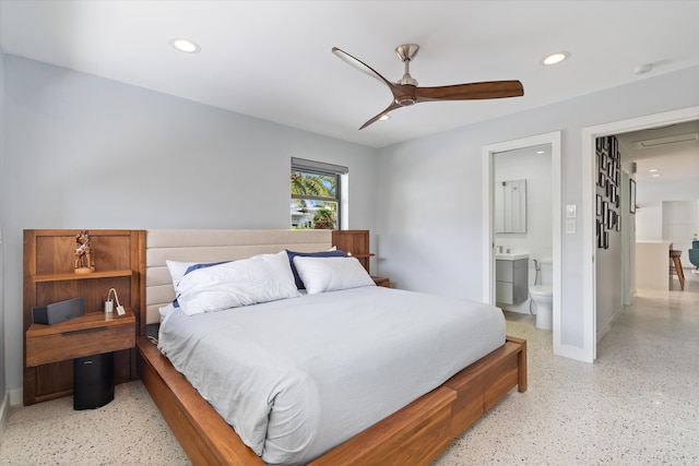 bedroom featuring light speckled floor, ceiling fan, ensuite bathroom, recessed lighting, and baseboards