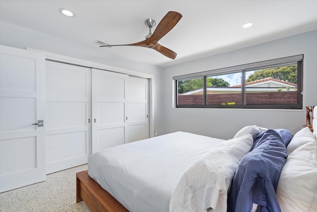 bedroom with ceiling fan, recessed lighting, speckled floor, visible vents, and a closet