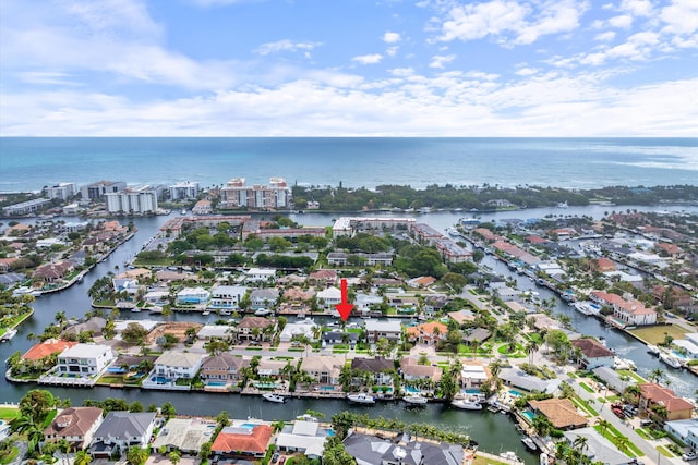 drone / aerial view featuring a water view and a residential view