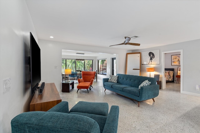 living area featuring baseboards, visible vents, a ceiling fan, light speckled floor, and recessed lighting