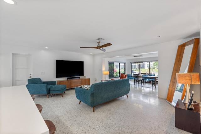 living room with recessed lighting, a ceiling fan, and speckled floor