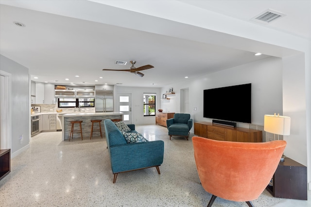 living room featuring ceiling fan, visible vents, and recessed lighting