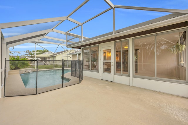 view of swimming pool with glass enclosure, a fenced in pool, and a patio