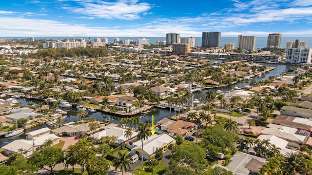 birds eye view of property featuring a view of city and a water view