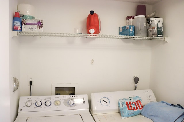 clothes washing area featuring laundry area and washer and clothes dryer