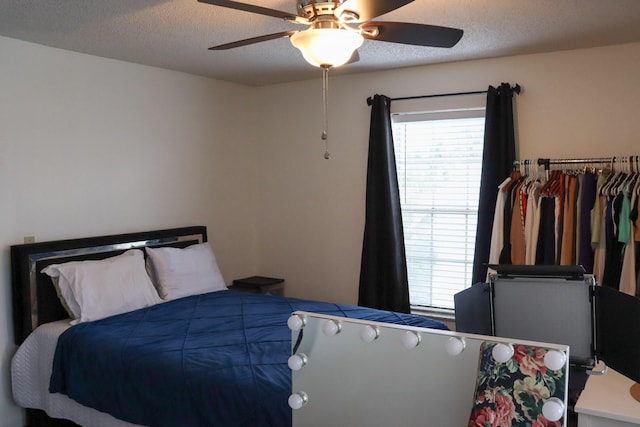 bedroom with a textured ceiling and ceiling fan