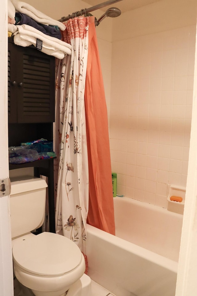 full bath featuring toilet and shower / bath combo with shower curtain