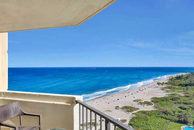 balcony featuring a beach view and a water view