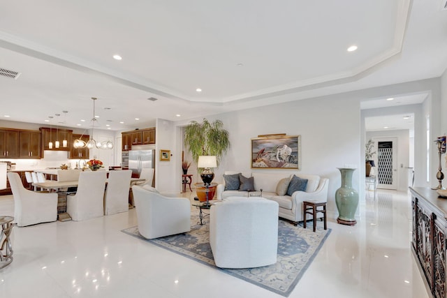 living room featuring a raised ceiling, visible vents, and recessed lighting