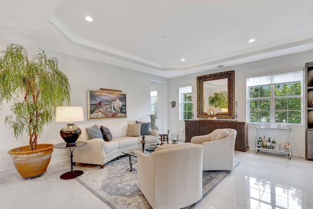 living area featuring light tile patterned flooring, a raised ceiling, a wealth of natural light, and recessed lighting