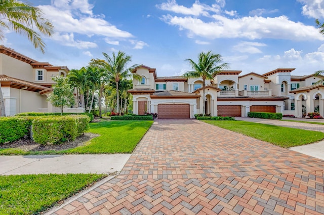 view of front of property featuring a garage, a residential view, decorative driveway, and stucco siding