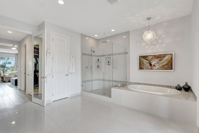 full bath with recessed lighting, a bath, tile patterned floors, a stall shower, and a walk in closet