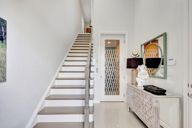 staircase with tile patterned flooring