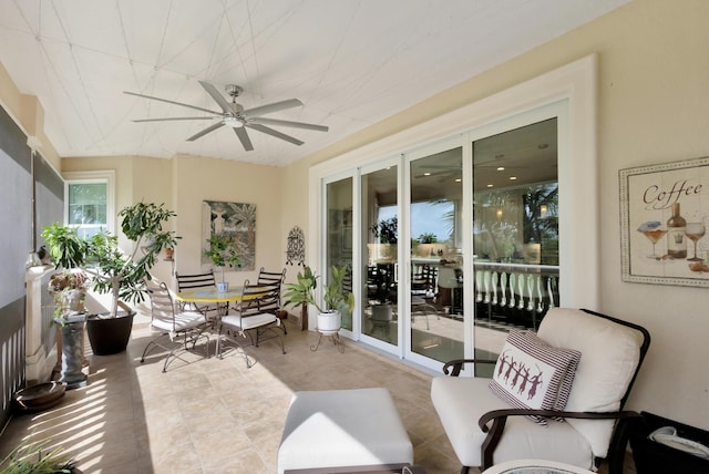 sunroom featuring ceiling fan