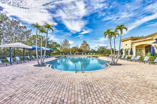 pool with a patio, a gazebo, and fence