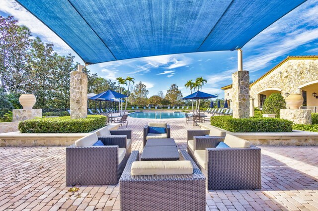 view of patio with an outdoor hangout area and a community pool