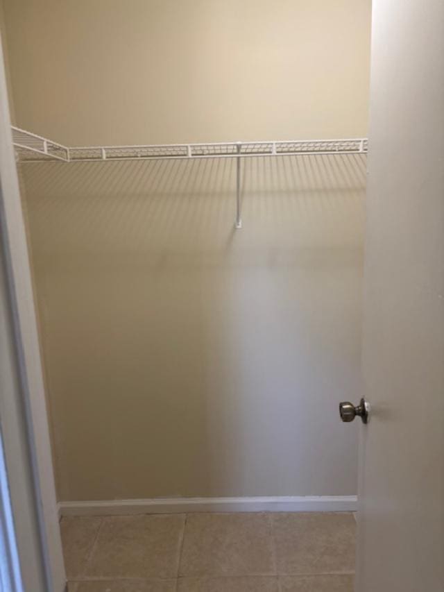 walk in closet featuring light tile patterned flooring