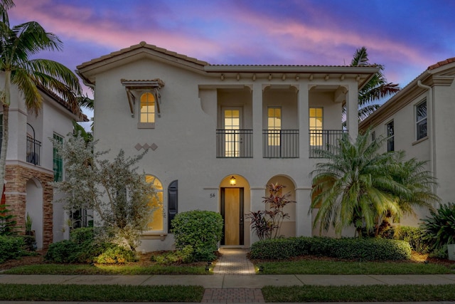 mediterranean / spanish-style house featuring a tile roof and stucco siding