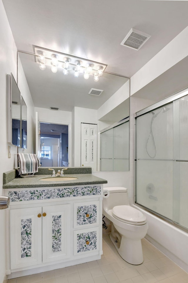 bathroom with toilet, combined bath / shower with glass door, vanity, and visible vents