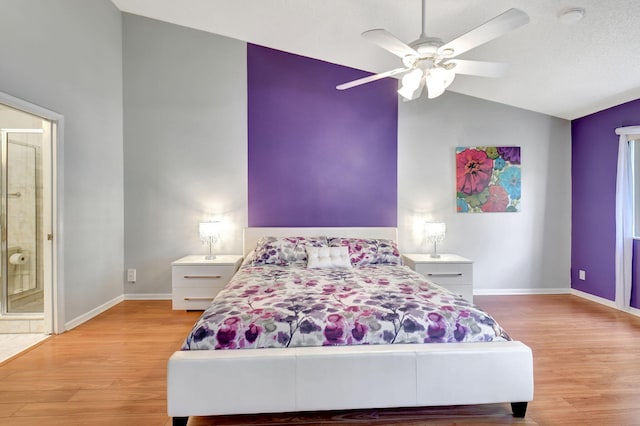 bedroom featuring light wood-type flooring, ceiling fan, baseboards, and lofted ceiling