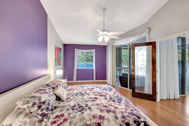 bedroom with access to outside, ceiling fan, lofted ceiling, and wood finished floors