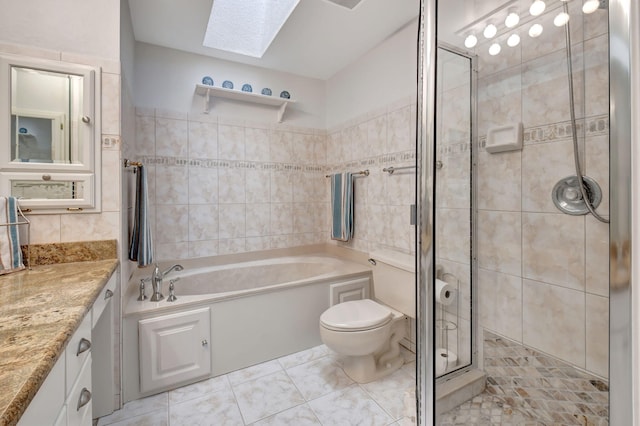 full bath with a skylight, a garden tub, vanity, a shower stall, and tile walls