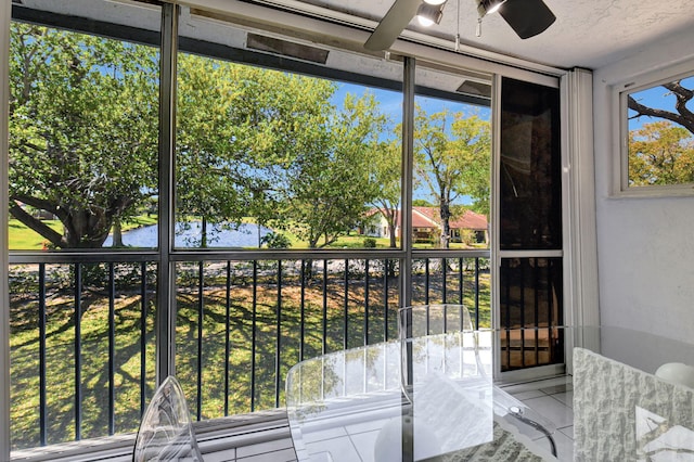 unfurnished sunroom with a ceiling fan