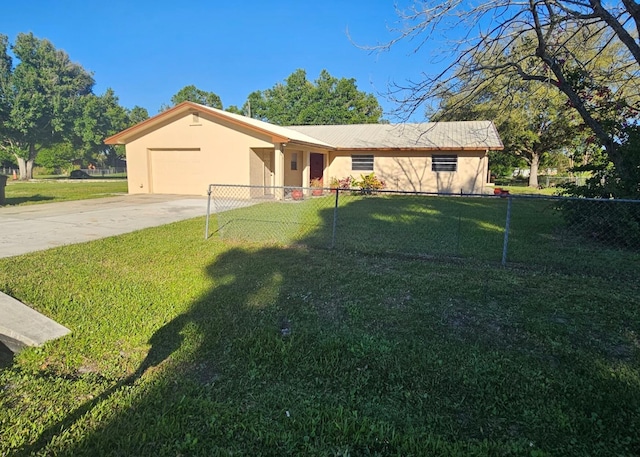 view of front of property with concrete driveway, an attached garage, a front lawn, and stucco siding