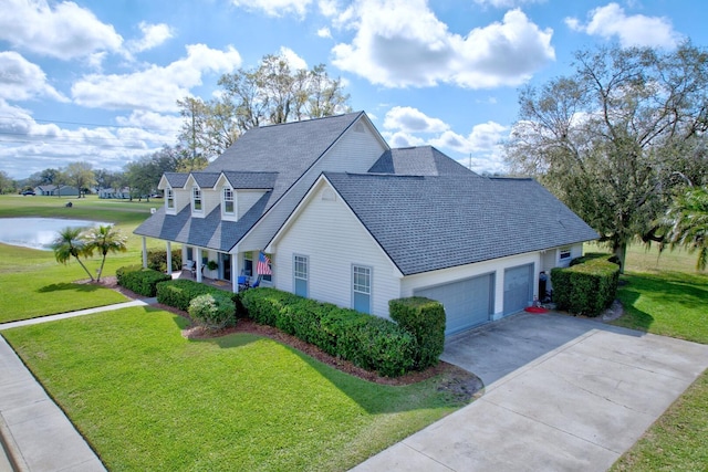 view of front of house with a porch, a front yard, driveway, and an attached garage