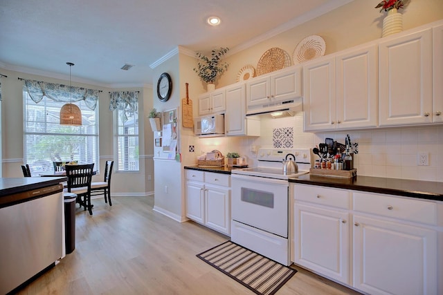 kitchen featuring dark countertops, white appliances, under cabinet range hood, and white cabinetry