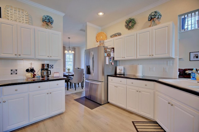 kitchen featuring ornamental molding, white cabinetry, a sink, light wood-type flooring, and stainless steel fridge with ice dispenser