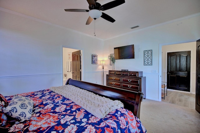 carpeted bedroom with ornamental molding, visible vents, and a ceiling fan